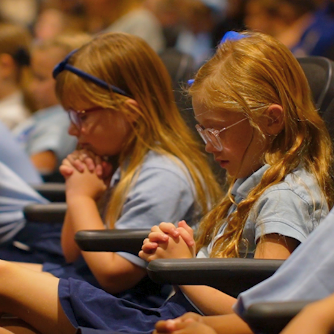 Two girls praying at Chapel