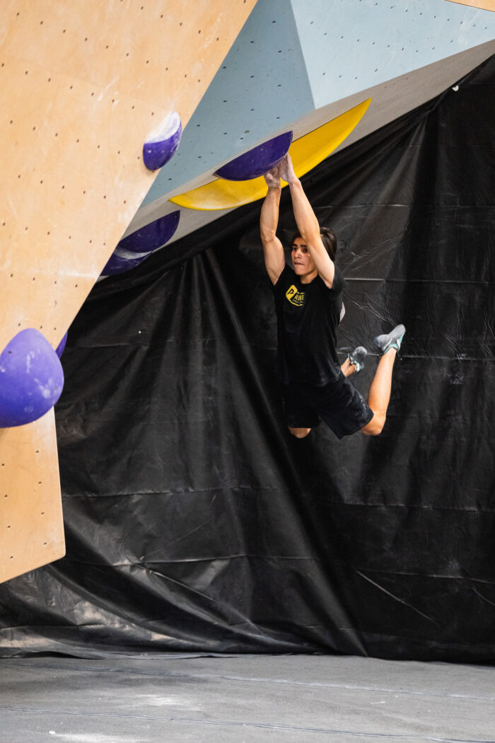 Jackson Day swinging on a climbing wall