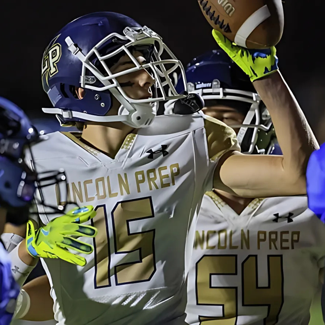 Connor Mewhinney holding a football in uniform