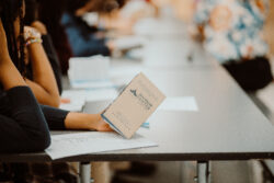 Pocket Constitution booklet held by a student
