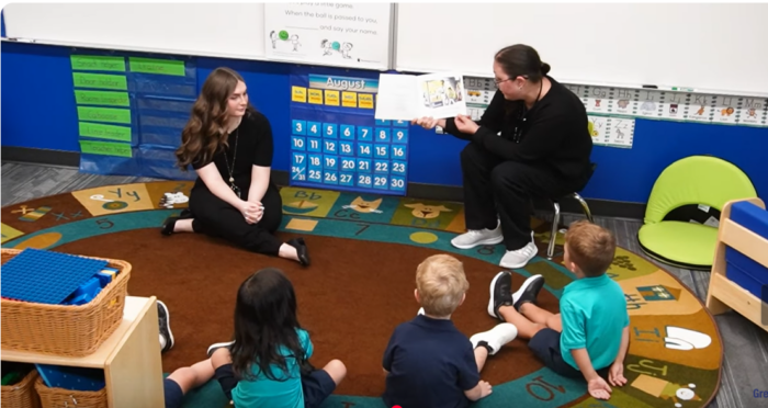 Young Hearts teachers reading to preschoolers