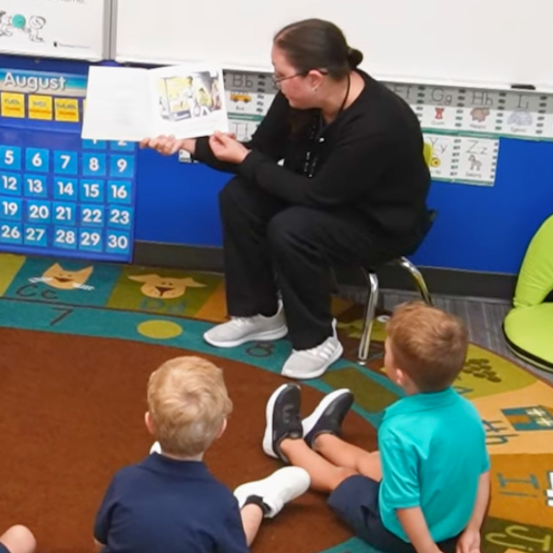 Young Hearts teachers reading to preschoolers