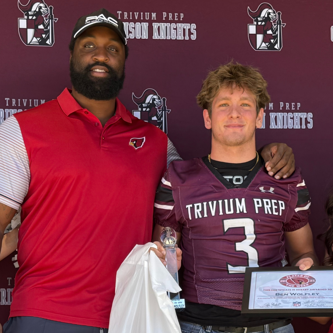 Trivium Prep Player with cheerleaders and Zach Moore