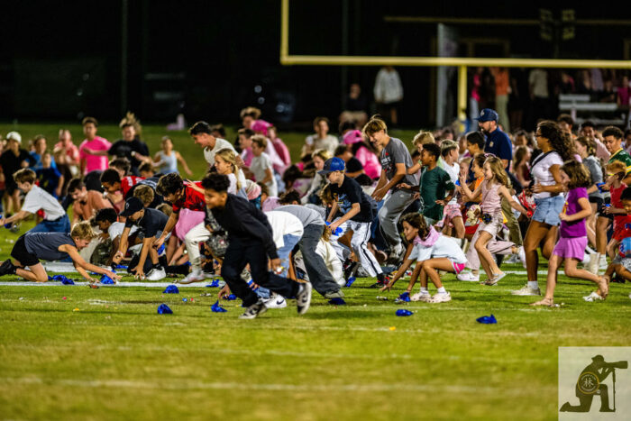 Children running onto the field