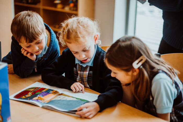 Great Hearts students reading a book together