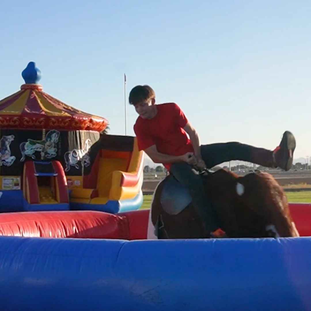 Student on mechanical bull at Fall Carnival