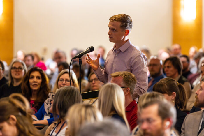 Symposium attendee asking a question from audience