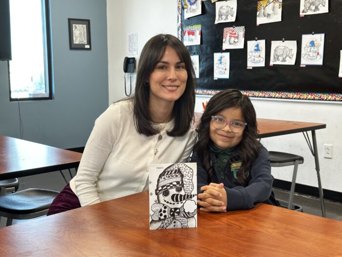 Girl and teacher with artwork