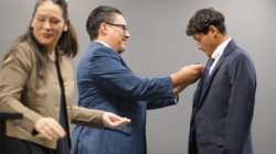Student receiving lapel pin