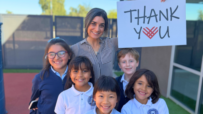 Students and faculty holding Thank You sign