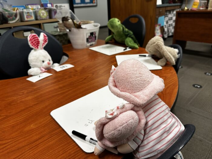 Toy animals sitting around a table