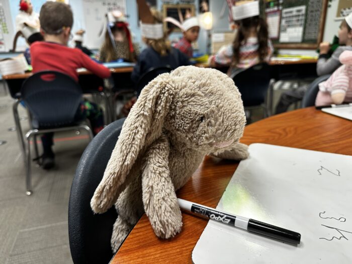Toy rabbit sitting at desk