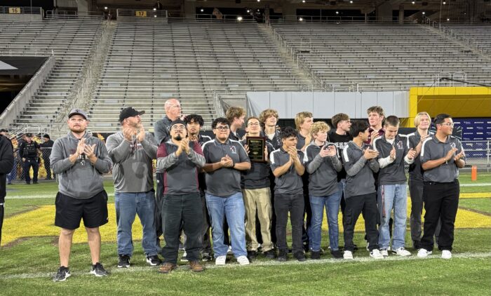 Trivium Prep football players standing on a field