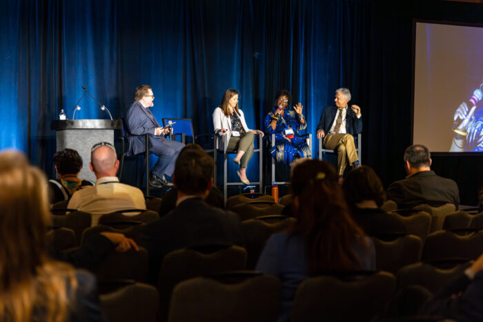 A panel on stage at Symposium