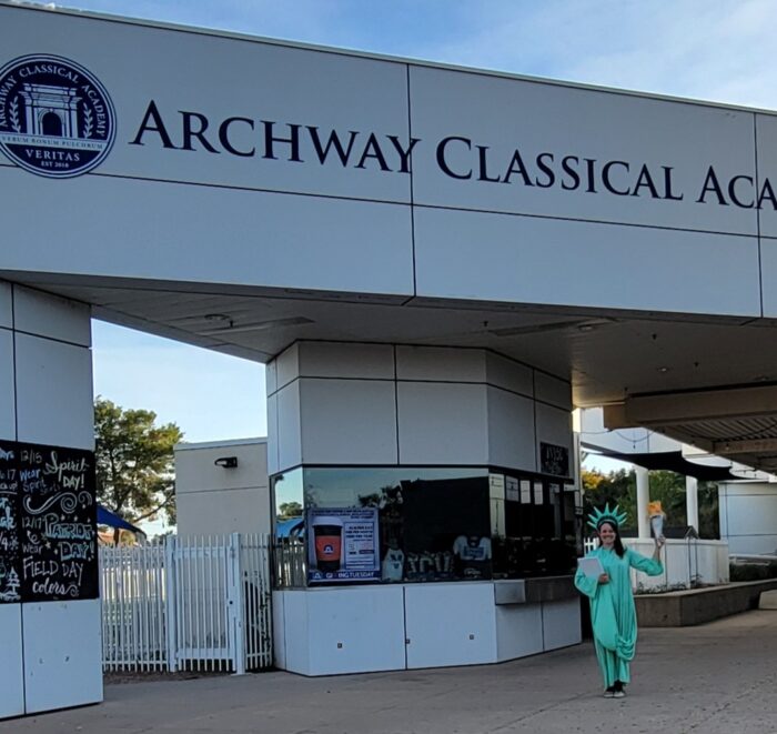 Headmaster dressed as Statue of Liberty in front of school