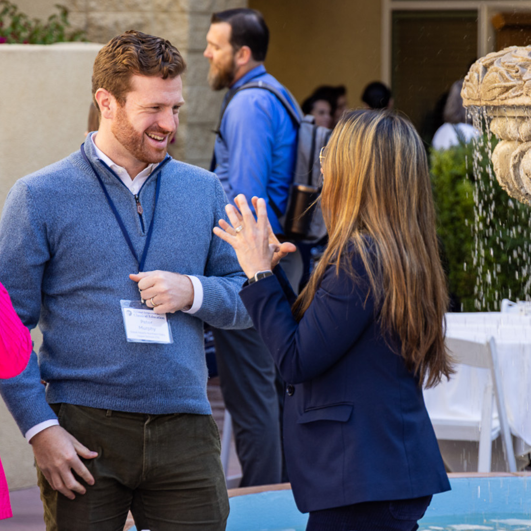 group of people laughing next to fountain