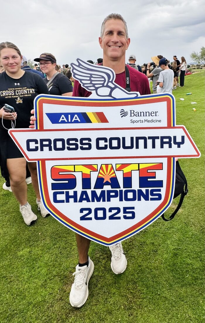 Coach Curtis with State Champions sign