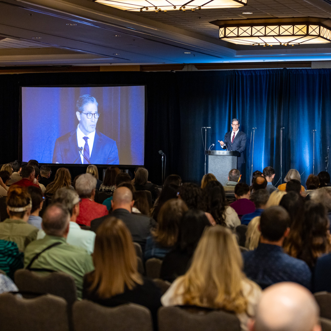 Dan Scoggin speaking to Symposium audience