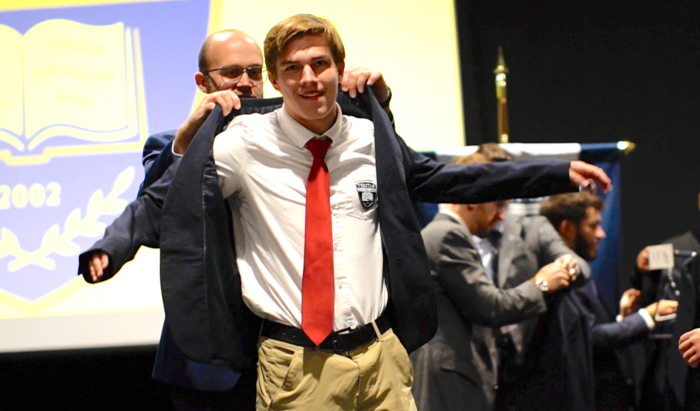 Student receiving a blazer