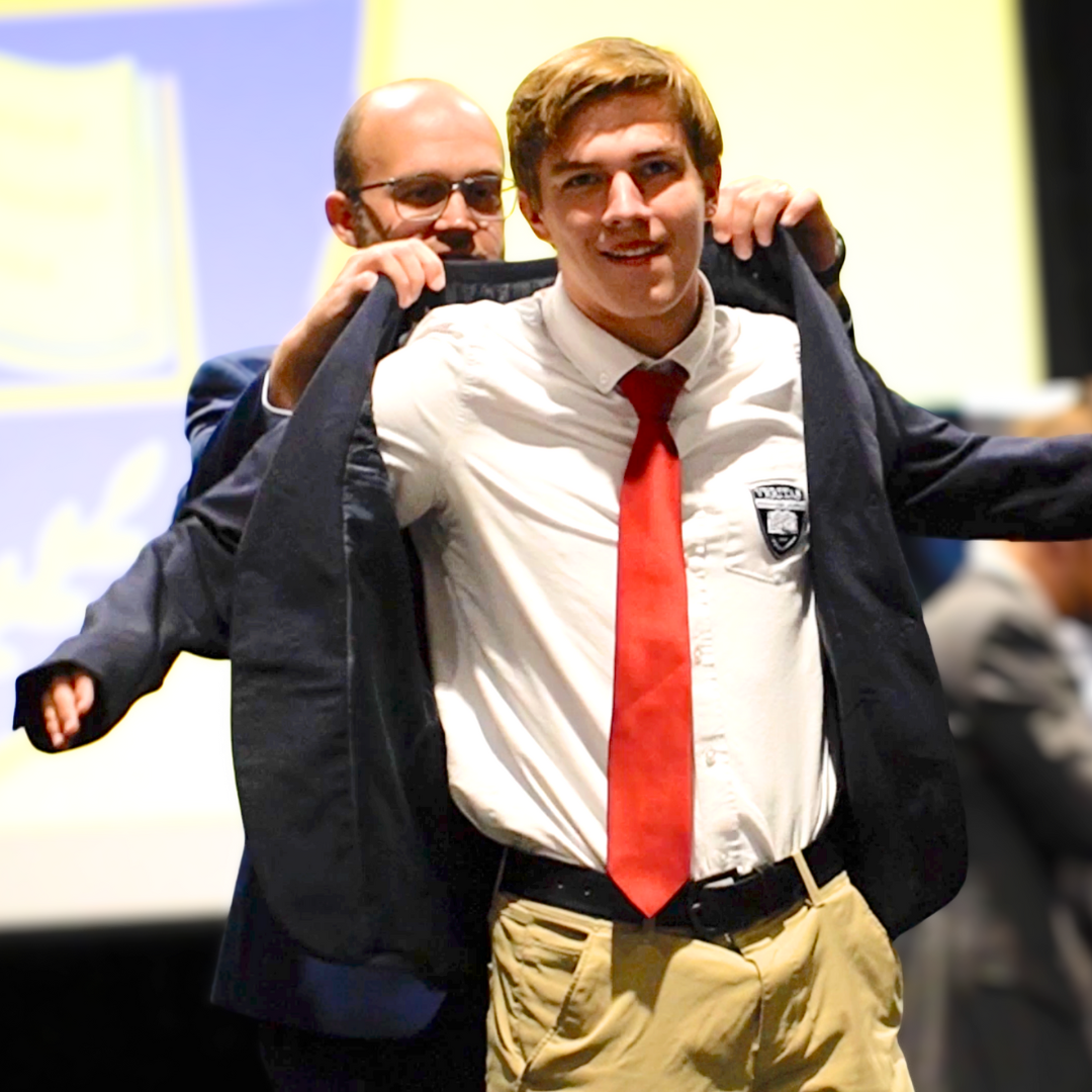 Student receiving a blazer