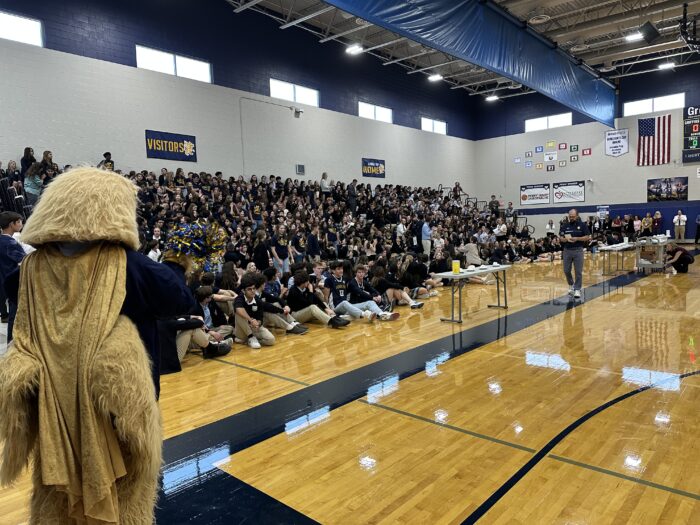 Students on the bleachers at a pep assembly