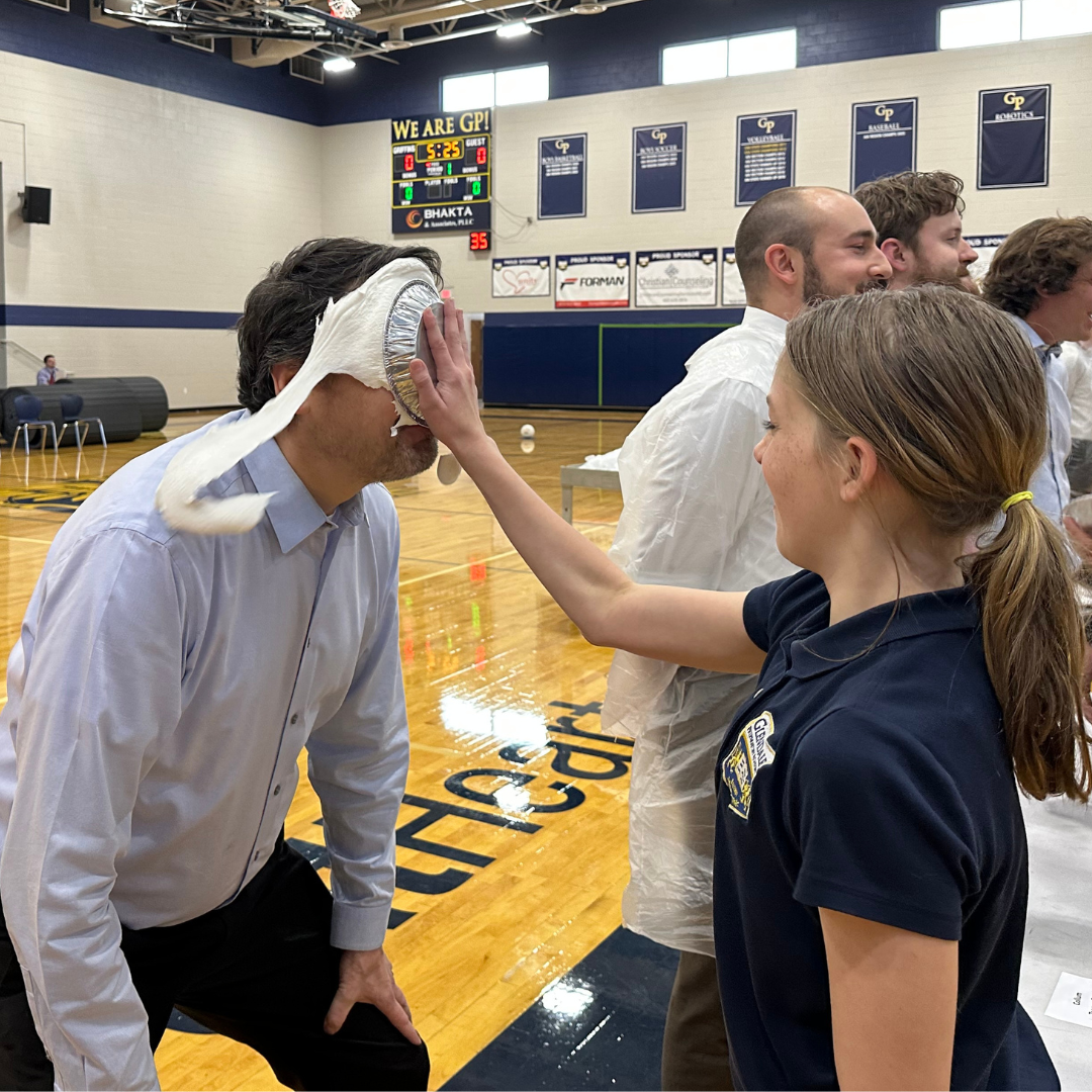Teacher receiving pie in the face from a student