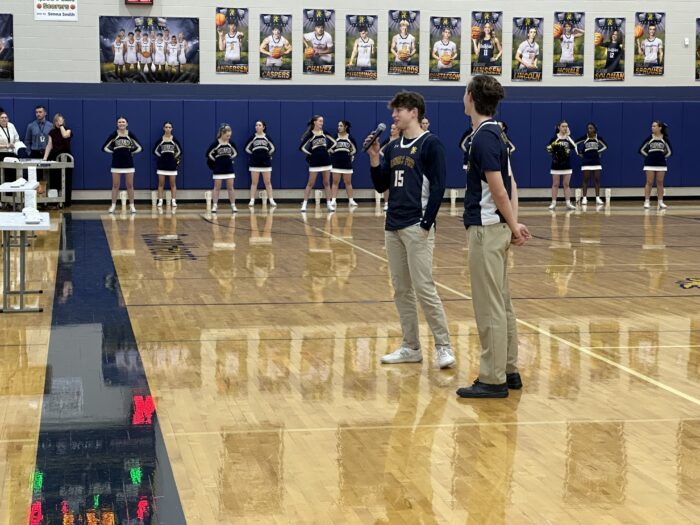 Two athletes presenting at pep assembly