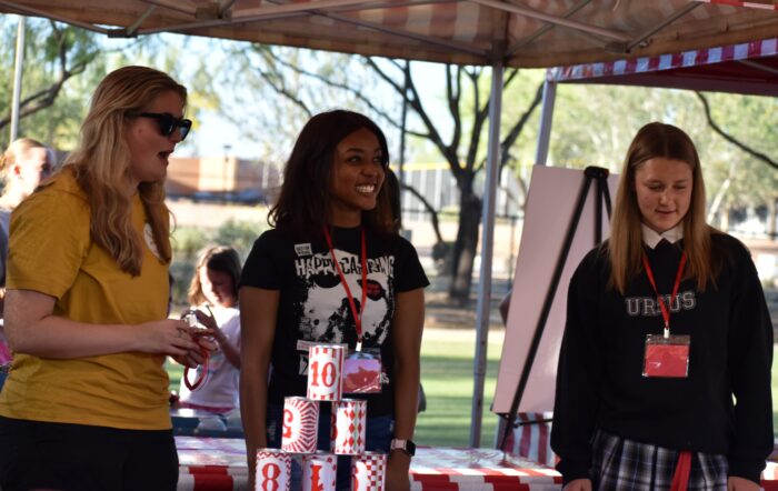 3 student volunteers at carnival