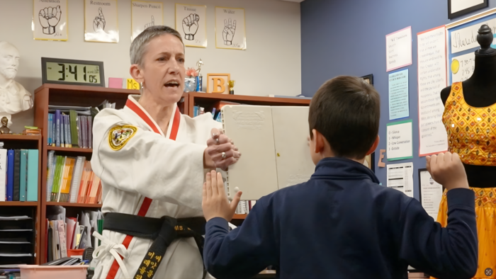 Taekwondo instructor with student