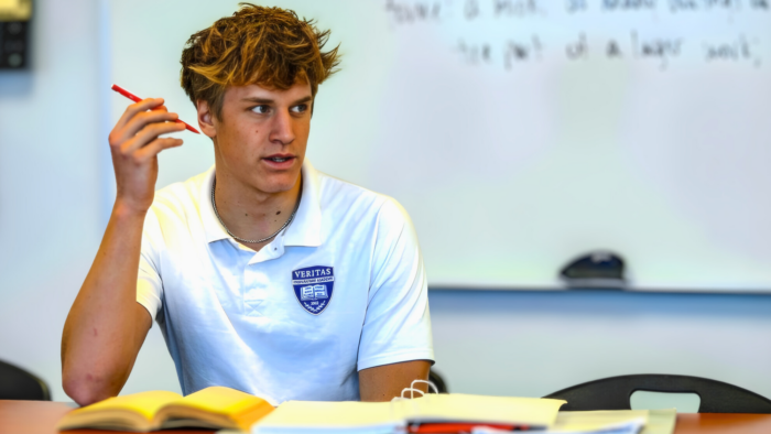 Upperclassmen student at desk in classroom
