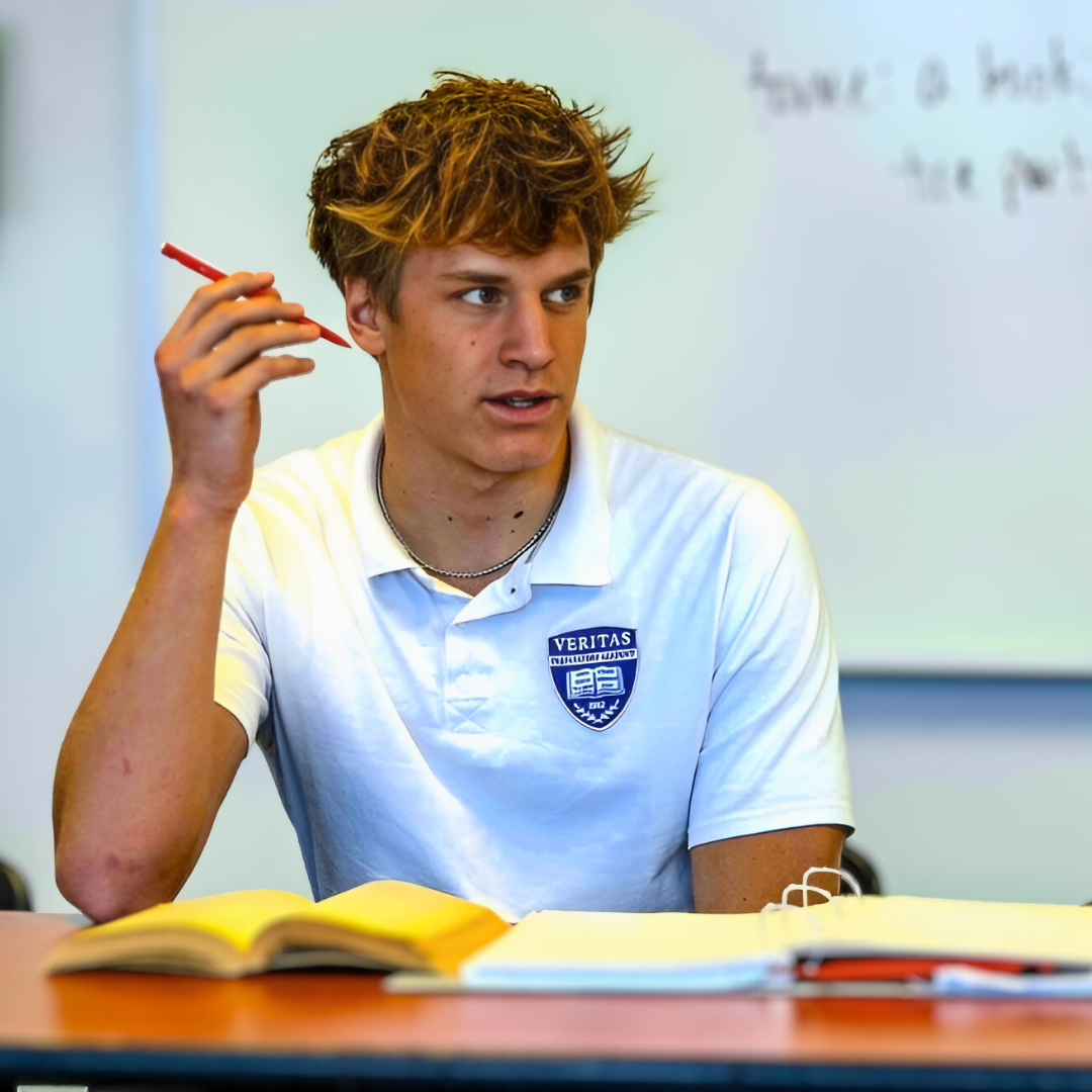 Upperclassmen student at desk in classroom