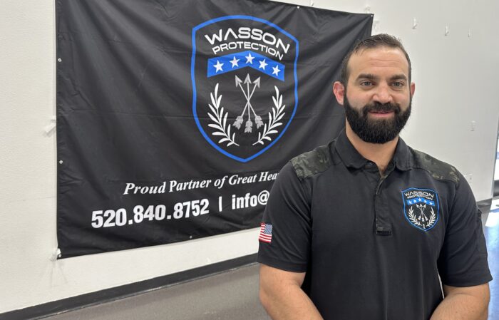 Wasson CEO in front of a Wasson flag