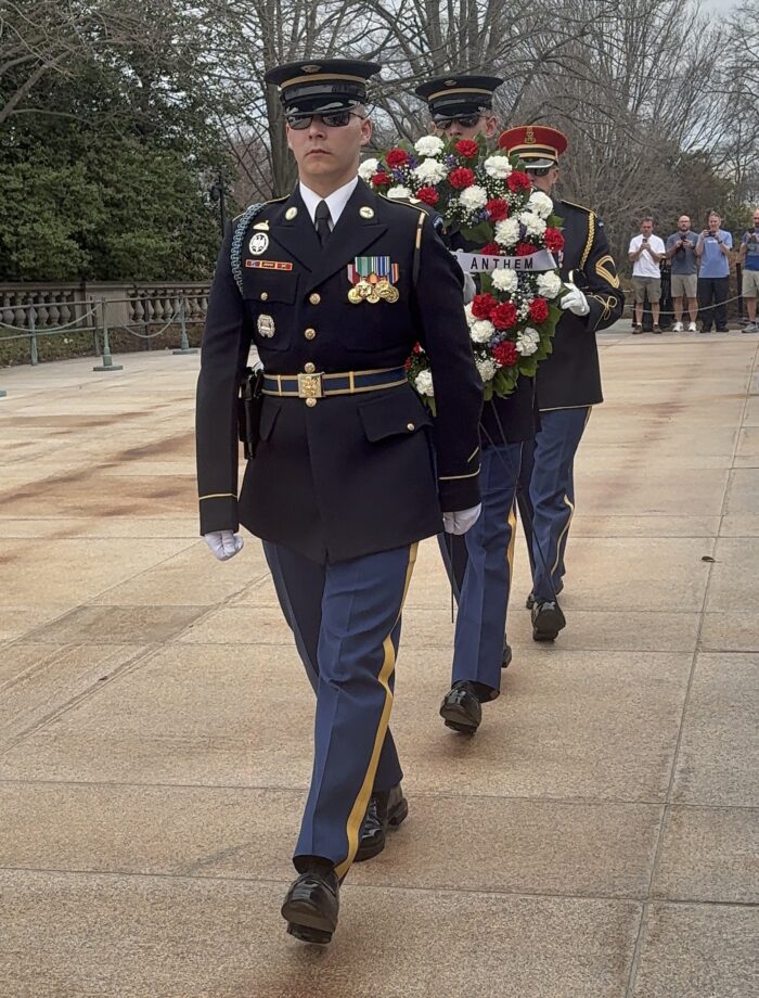 Officers marching with wreath