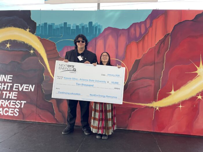 Students with a scholarship check