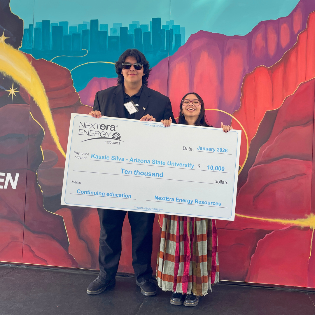 Students with a scholarship check