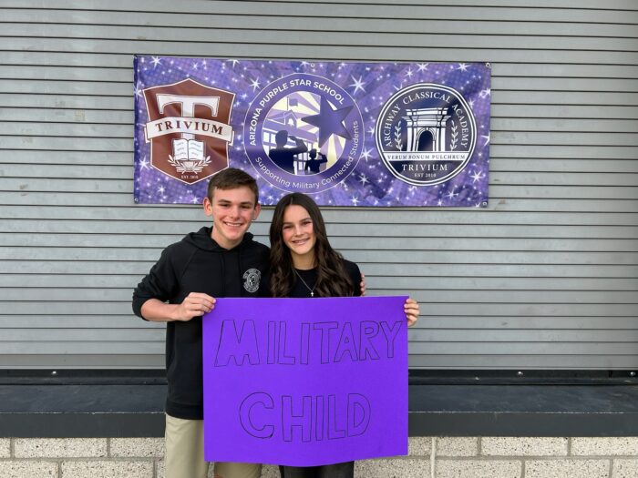 Two Students holding a purple Military Child sign