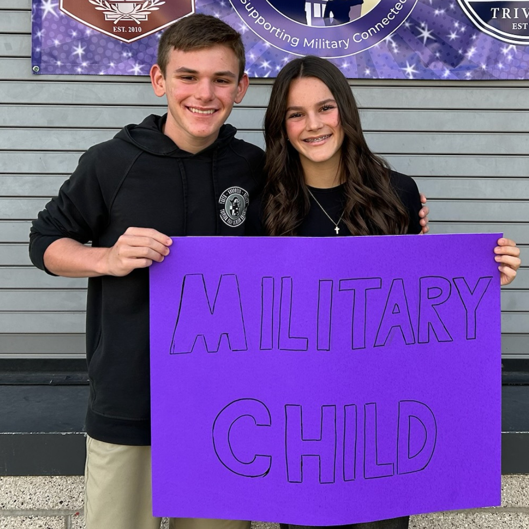 Two Students holding a purple Military Child sign
