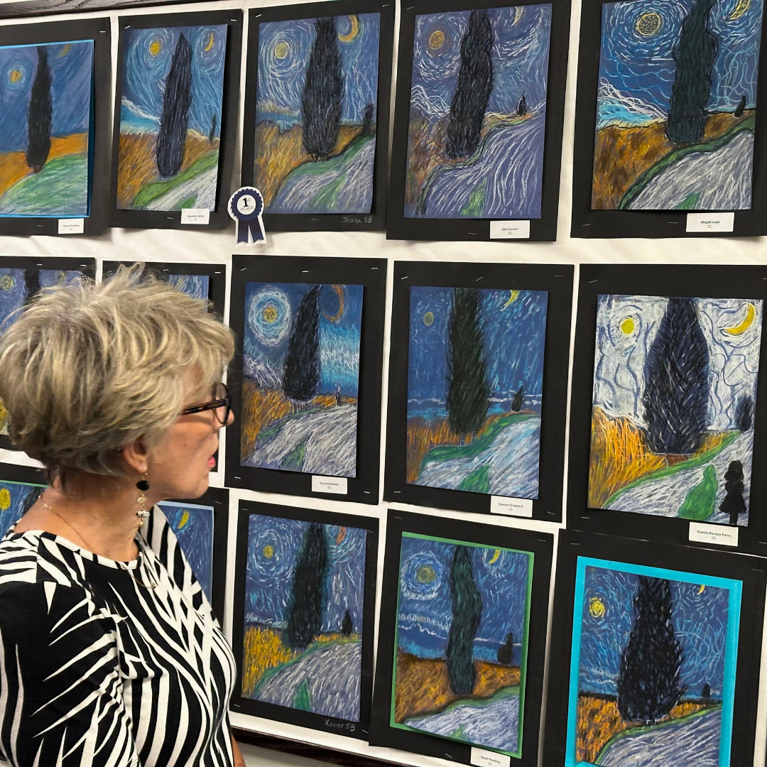 Parent looking at artwork at Art Night