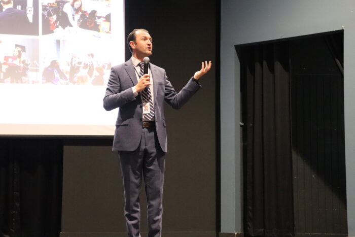 Brandon Crowe speaking on stage