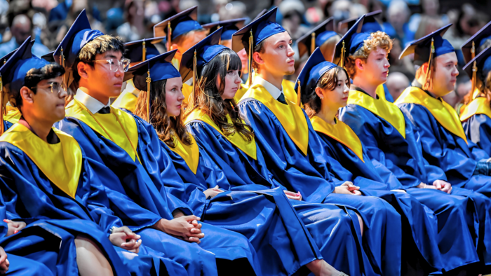 Group of graduates sitting in a line