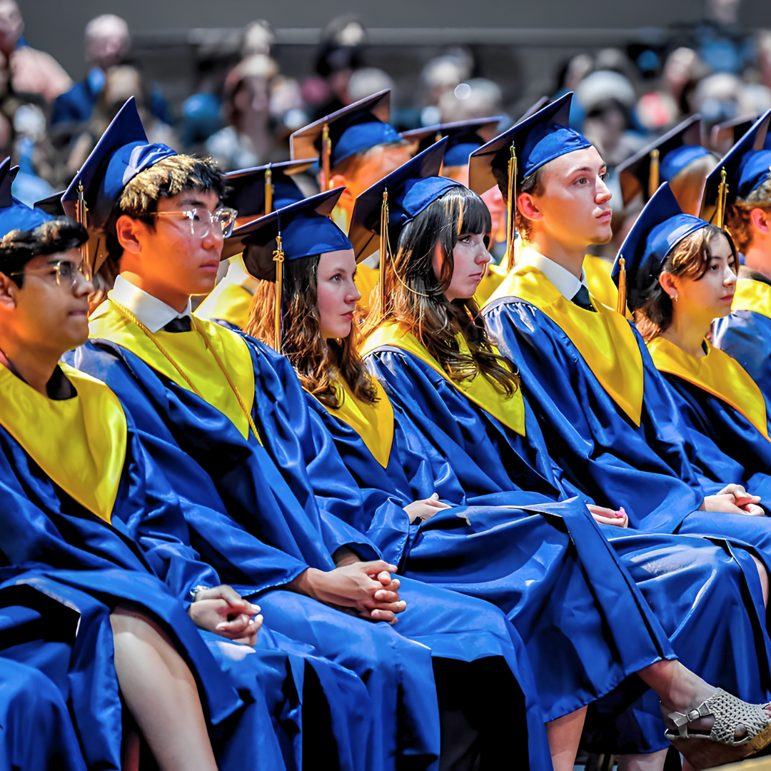 Group of graduates sitting in a line