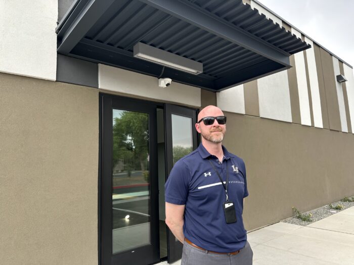 Headmaster outside of new building