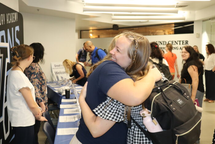 Two colleagues hugging