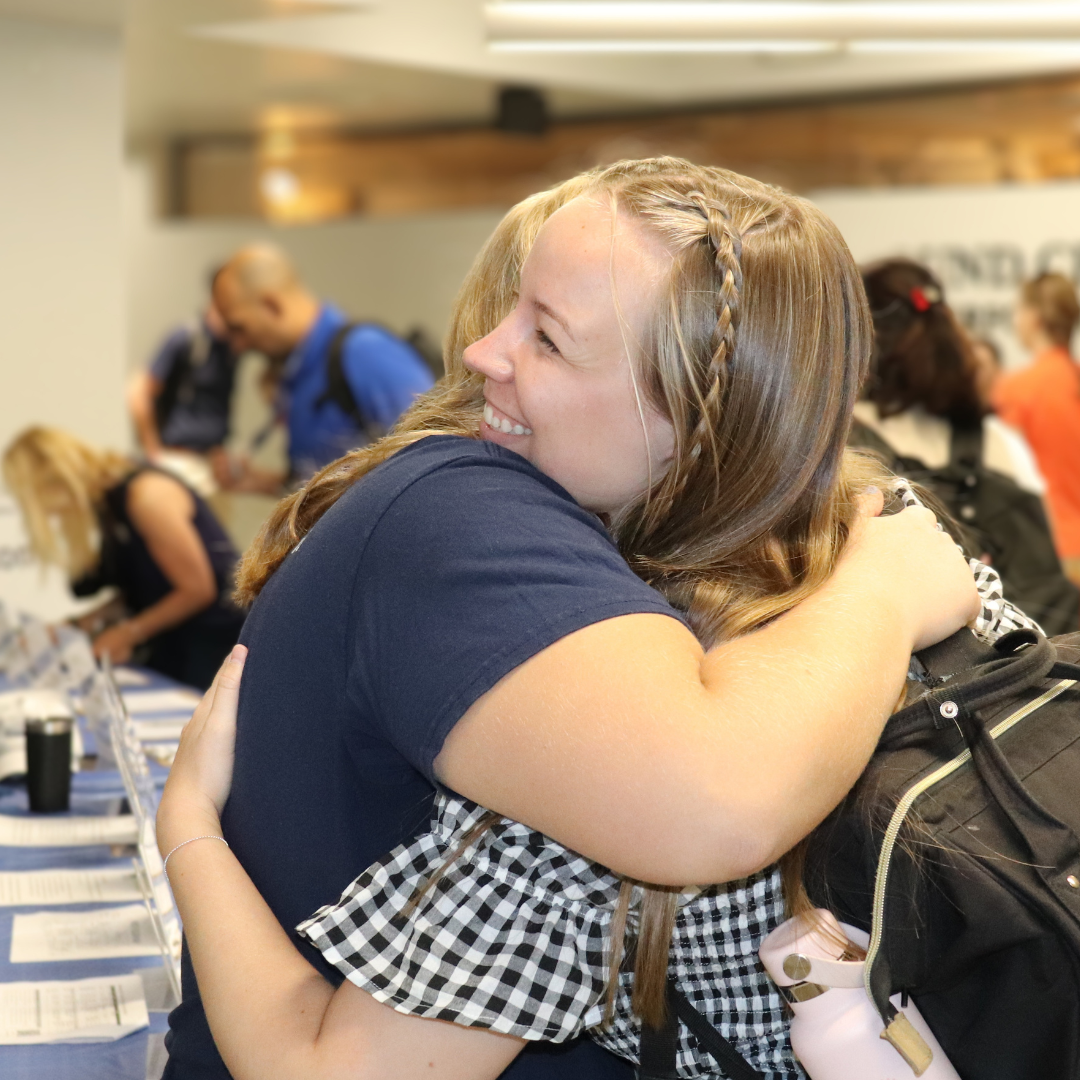 Two colleagues hugging