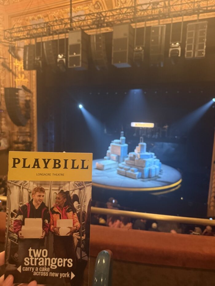 2 Strangers playbill with set in the background