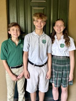 Two boys and a girl in school uniforms