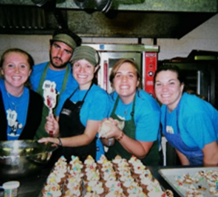 Megan Opitz in kitchen with coworkers