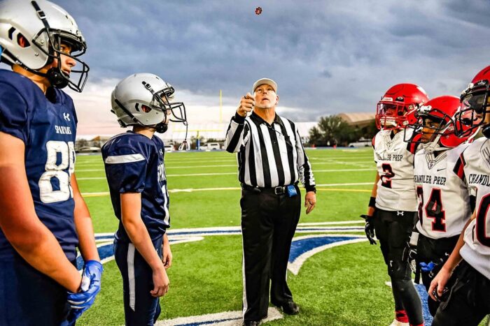 Ref flipping a coin at a football game