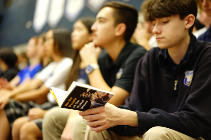 Scottsdale students in audience with booklet