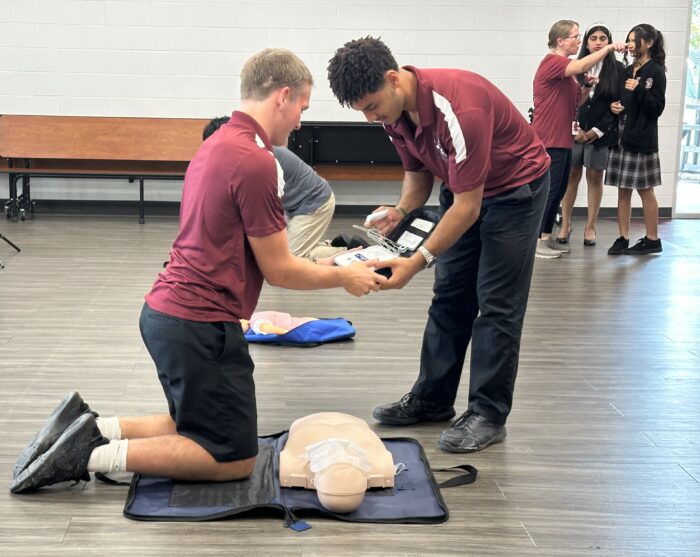 Two students working together with CPR equipment